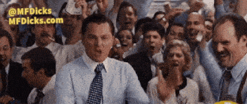 a man in a suit and tie stands in front of a crowd of people with the website mfdicks.com in the corner