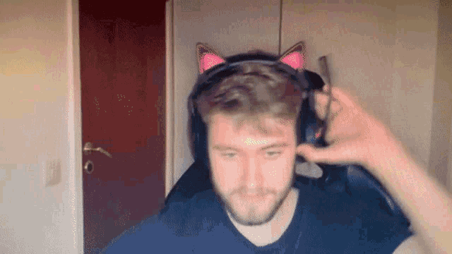 a man wearing headphones with cat ears on his head .