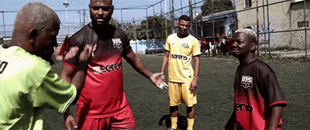 a group of soccer players are standing on a field and one of them is wearing a shirt that says ' regret '