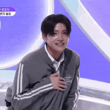 a young man wearing a jacket that says boys on planet on it