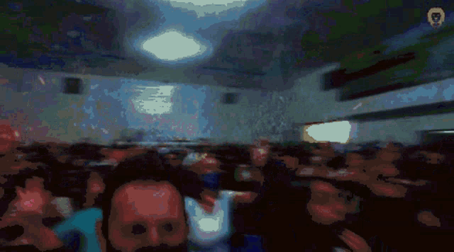 a blurred image of a crowd of people with the letter g on the bottom left