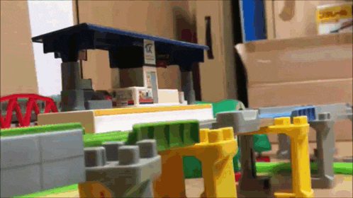 a toy train set with a blue roof and a sign that says ' a ' on it