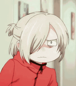 a girl with blonde hair is wearing a red jacket and making a funny face