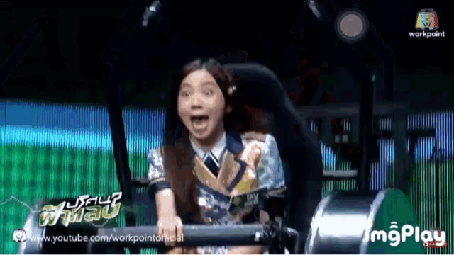 a girl is riding a roller coaster with the words workpoint on the bottom right