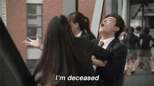 a man in a suit and tie is standing next to a woman in a school uniform and saying i 'm dead .