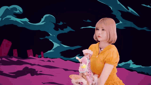 a woman in a yellow dress is holding a stuffed animal in her hands