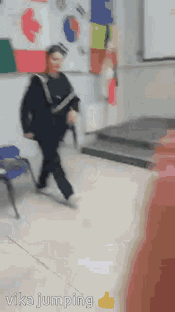 a person is jumping in the air in a classroom