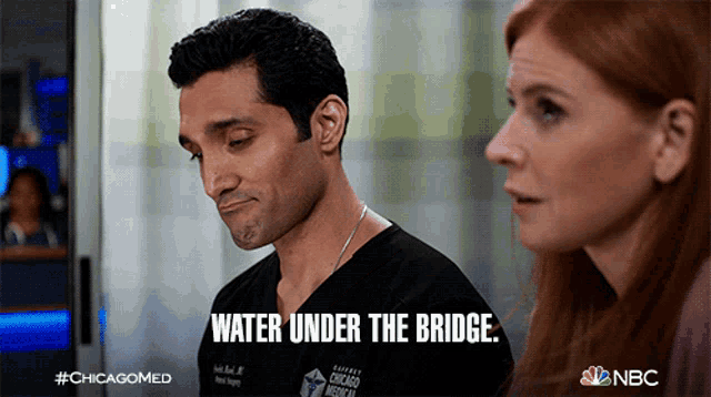 a man and a woman are standing next to each other and the man says " water under the bridge "