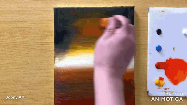 a painting is being painted on a canvas by a person named joony art