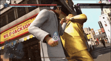 a man in a suit is fighting another man in front of a wild jackson restaurant