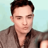 a man is taking a picture of himself with a camera and making a funny face .