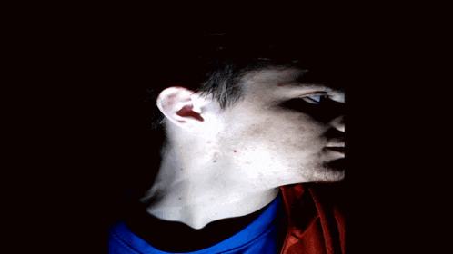 a man with a shadow on his face looks like a clown