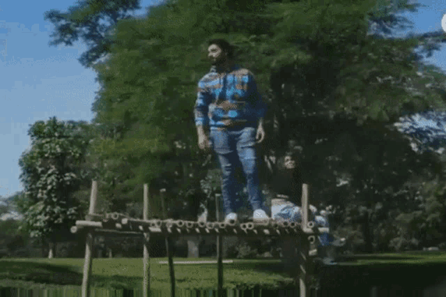 a man standing on a wooden bridge next to a woman