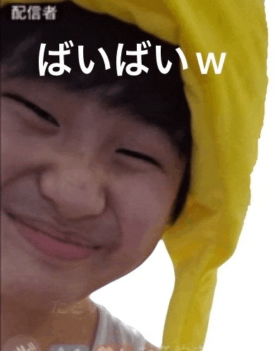 a close up of a person wearing a yellow hat and making a face .