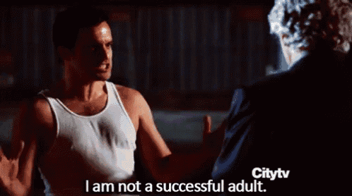 a man in a white tank top says i am not a successful adult in front of a man in a black suit