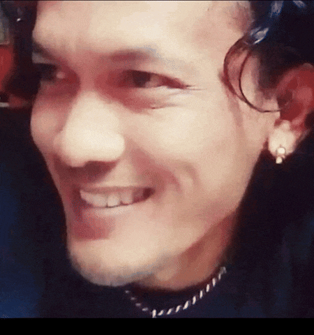 a close up of a man 's face with a smile on his face