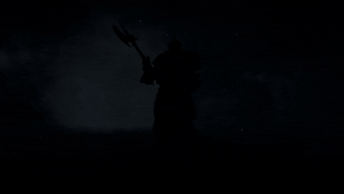 a statue of a man in armor holding a spear on a black background
