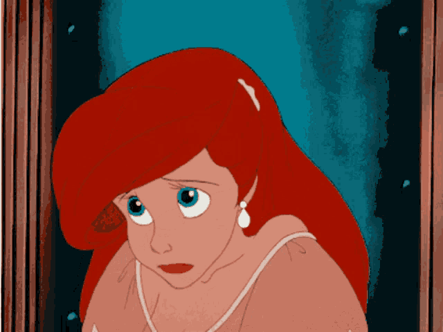 a close up of a cartoon character with red hair and blue eyes
