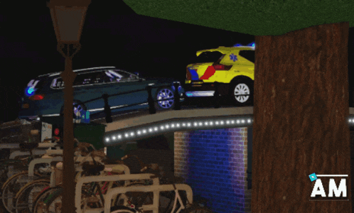 a blue car is parked on a bridge next to a yellow car