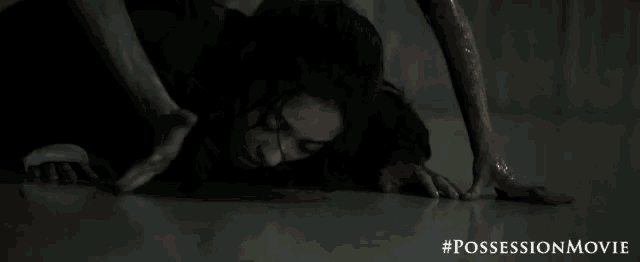 a woman is crawling on the floor with a #possessionmovie written on the bottom