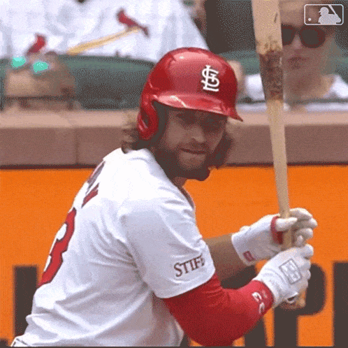 a baseball player wearing a red helmet with a s on it