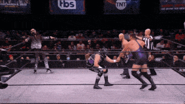 a wrestling ring with a tnt sign on the wall