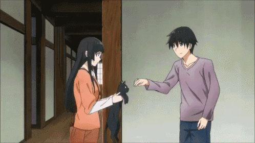 a man and a woman are standing next to each other in a hallway .