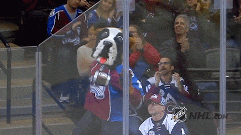 a mascot for the colorado avalanche is surrounded by fans
