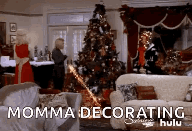 a living room decorated for christmas with a christmas tree and a couch .