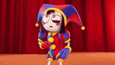 a cartoon character wearing a jester costume is standing in front of a red curtain .