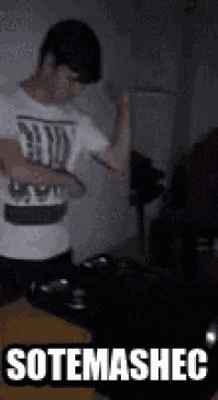 a man in a white shirt is dancing in a dark room with the words sotemashec written on the bottom