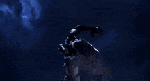a dragon with red wings is flying over a city