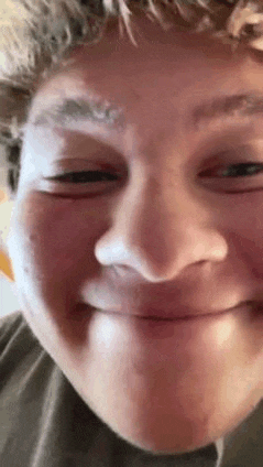 a close up of a person 's face with a smile on it .