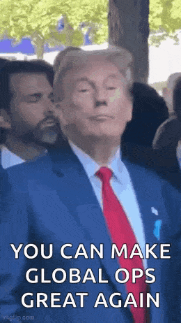 a man in a suit and tie is making a funny face while standing in front of a crowd .