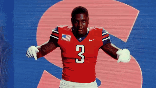 a man wearing a red jersey with the number 3 on it