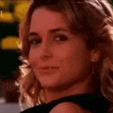 a close up of a woman 's face with a black dress on .