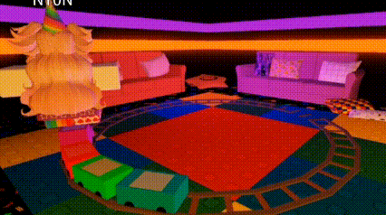 a room with a colorful rug , couch , and a train going around it .