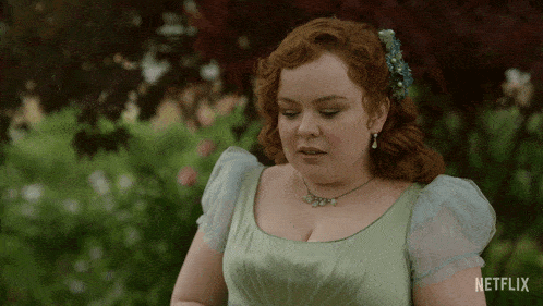 a woman in a green dress with a netflix logo on the bottom right