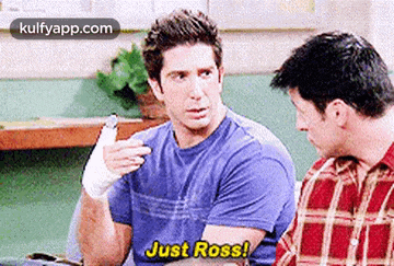 two men are sitting next to each other and one of them is wearing a bandaged hand .