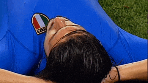 a man in a blue shirt with a patch that says italia on it