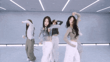 a group of women are dancing in a room