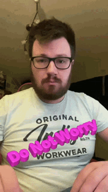 a man wearing glasses and a t-shirt that says do not worry workwear