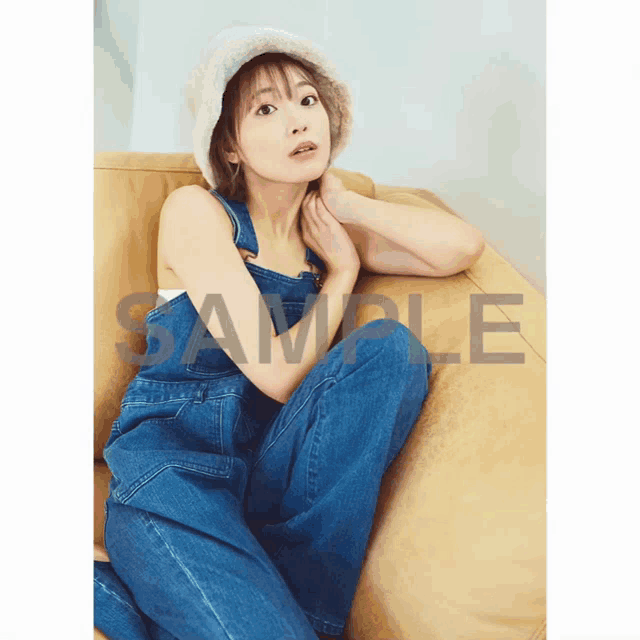 a woman in overalls sits on a couch with the word sample on the bottom