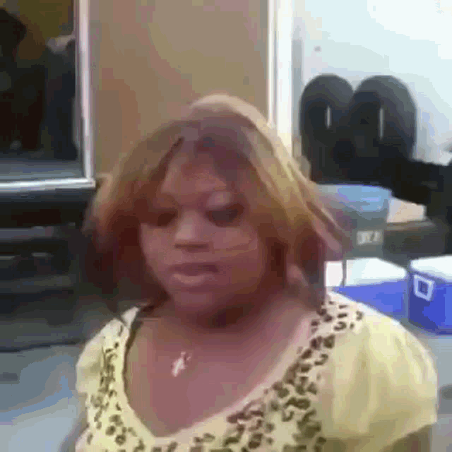 a woman in a yellow shirt with a leopard print on it