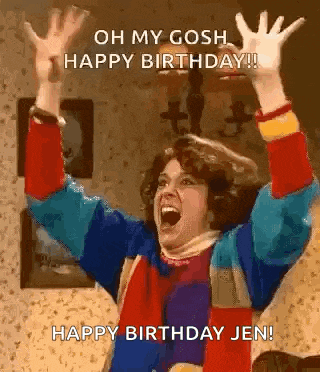 a woman is celebrating her birthday with her arms in the air and her mouth open .