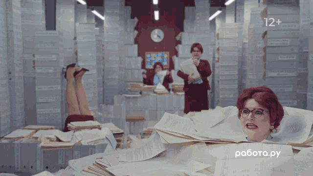 a woman with glasses is surrounded by stacks of papers and a sign that says работа.py