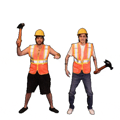two construction workers wearing hard hats and safety vests are holding hammers