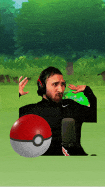 a man wearing headphones and holding a pokeball in front of a microphone