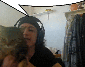a woman wearing headphones holds a cat in her arms