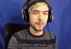 a man with green hair and headphones says pizza is glorious .